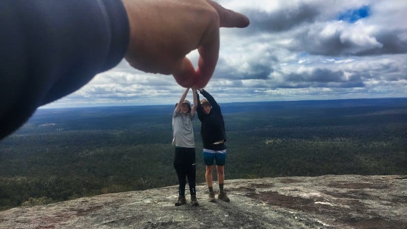 Fun photo that looks like someone is picking two teen boys up with two fingers