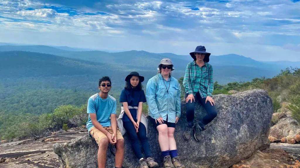 Three teens and a guide on Mount Cuthbert during a teen hike