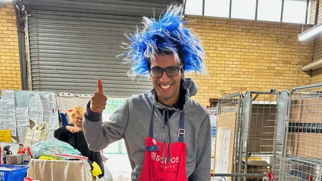 Guy with funny hat smiling with a thumb up