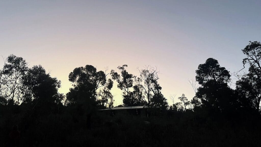 Sunrise over a Bibbulmun Track campsite by a teen hiker