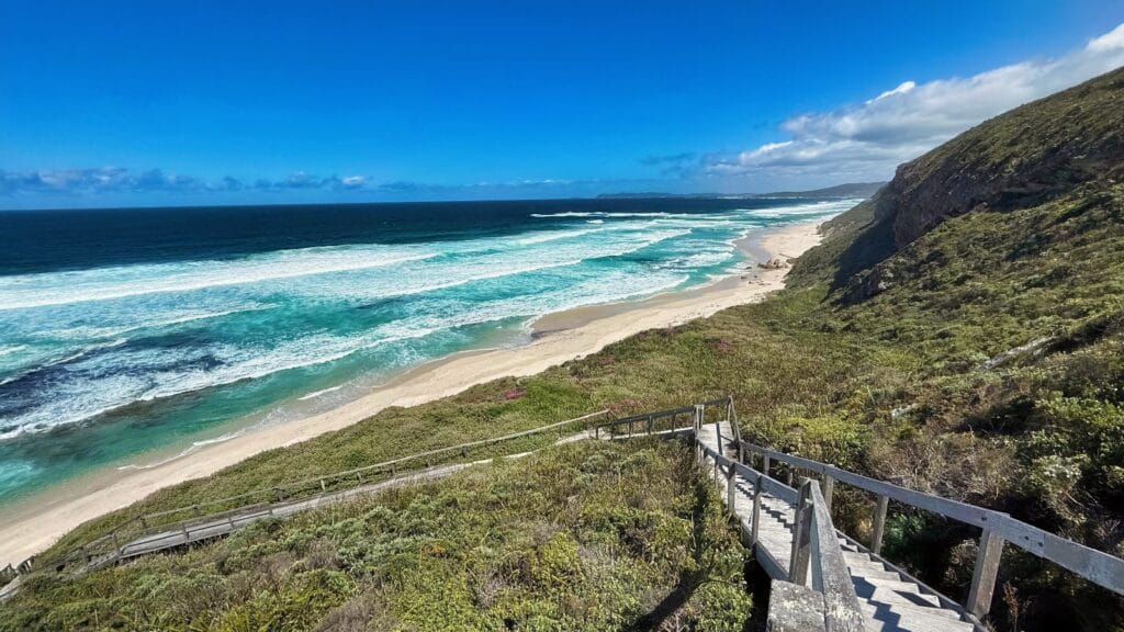 wooden steps going down to remote beach
