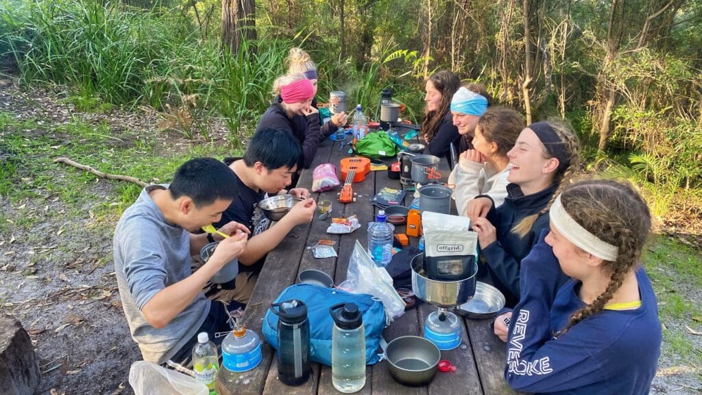 teens eating together after a hard day of hiking