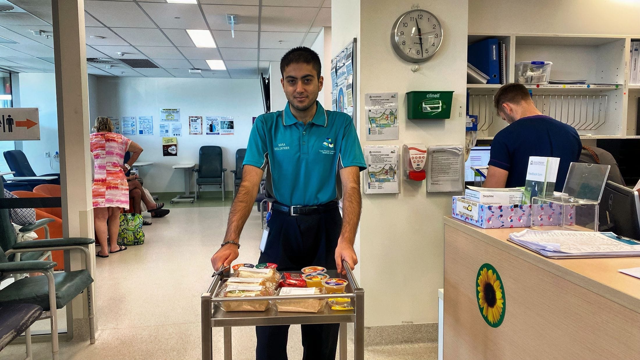 young man volunteering at fiona stanley hospital pushing a cart with lifetrail mentoring