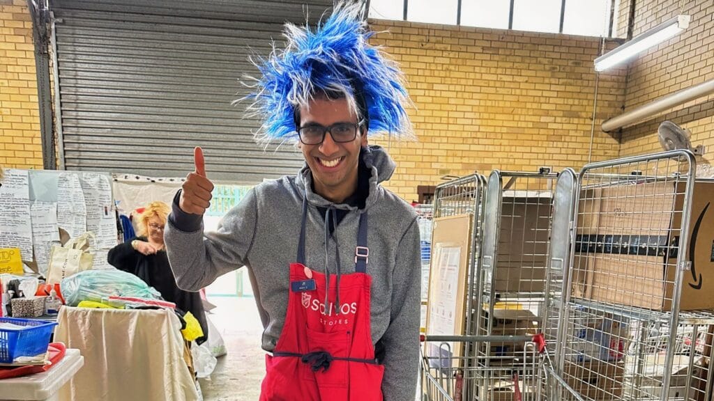 Guy with funny hat smiling with a thumb up