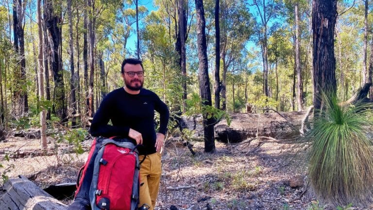 man in forest with his backpack