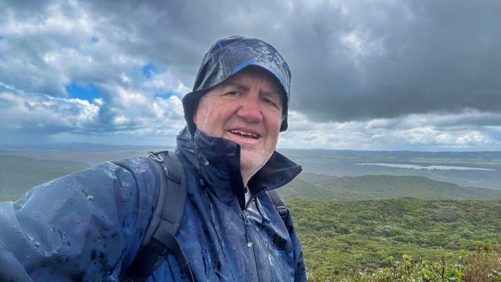a man in the rain on a day hike