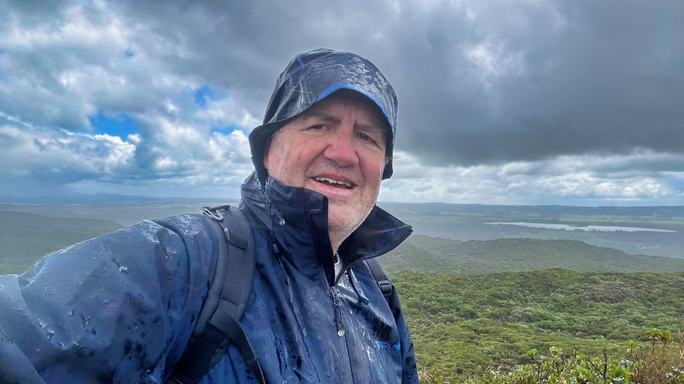 a man in the rain on a day hike