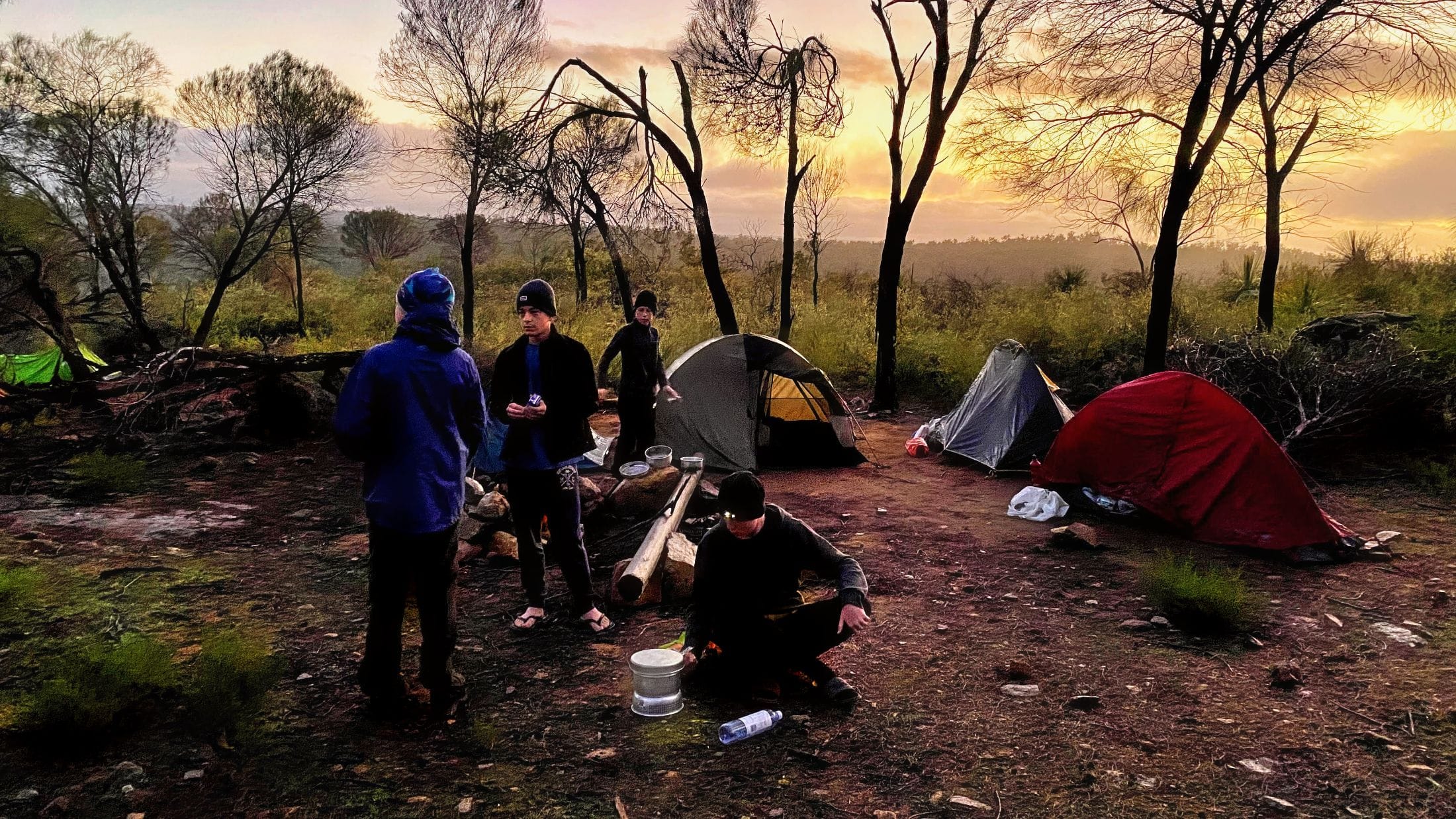 teens with tents during a hike