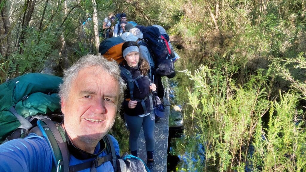 Didier guide and teens crossing flooded section