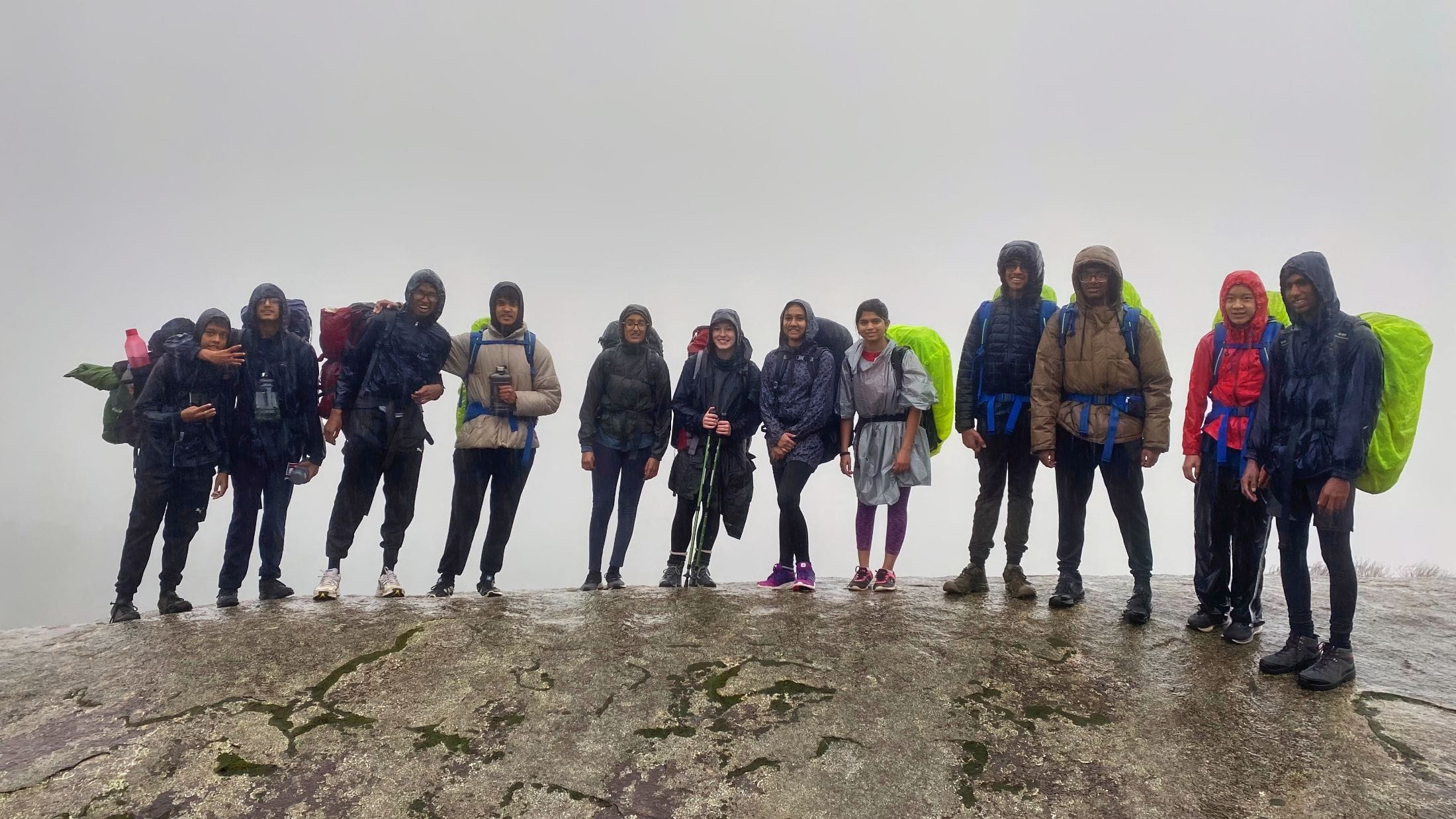 teens hiking in rain and mist