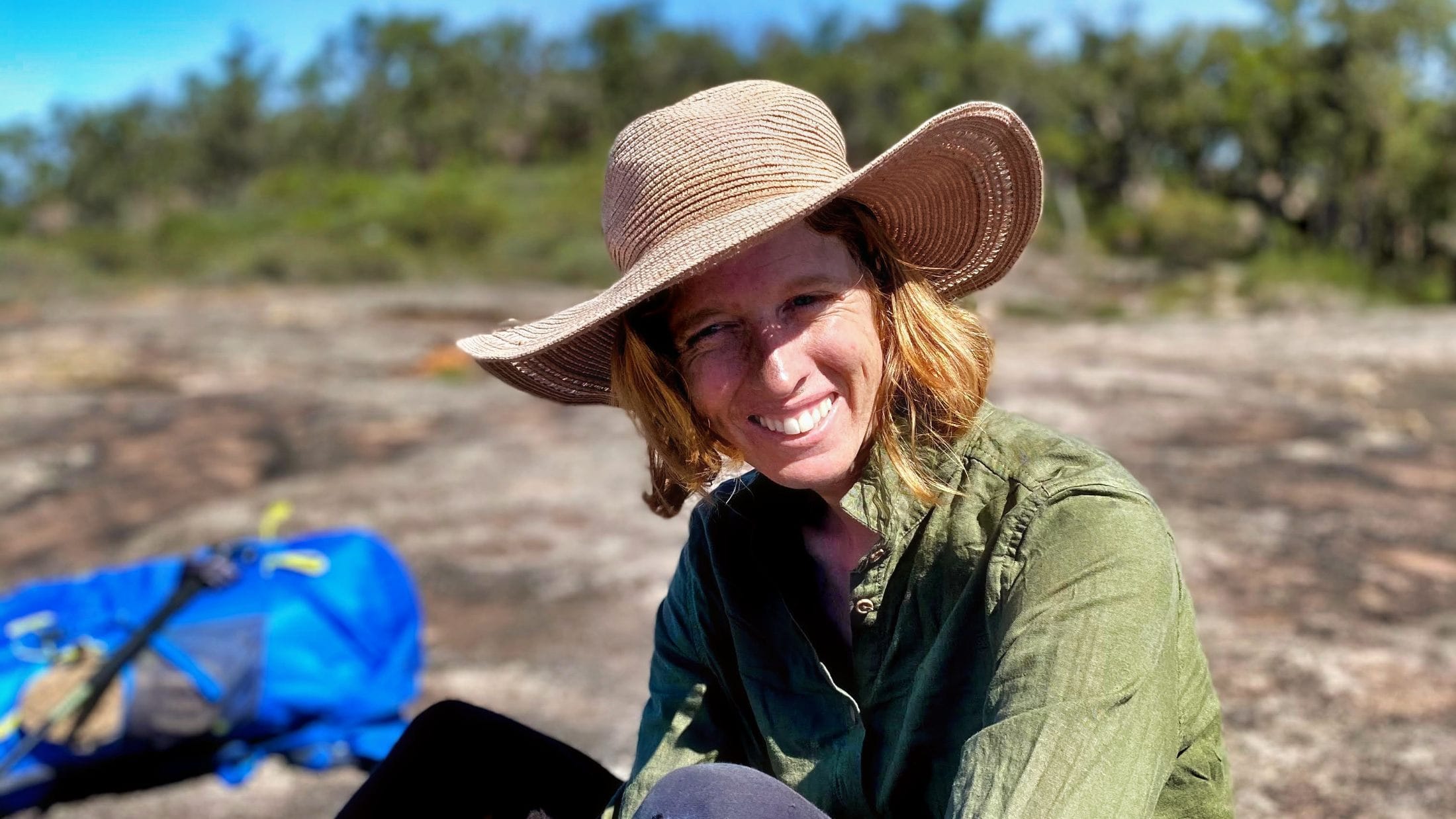 Lady with large hat enjoying a hike in the sun