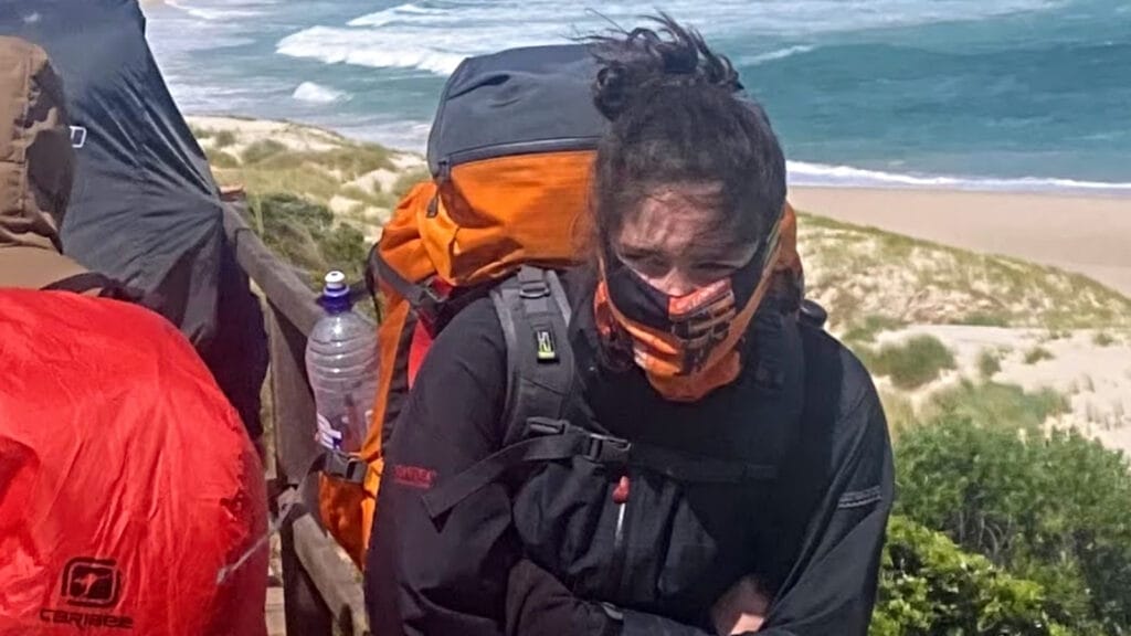 teen girl protecting her face against very cold winds near the south coast on the Bibbulmun Track