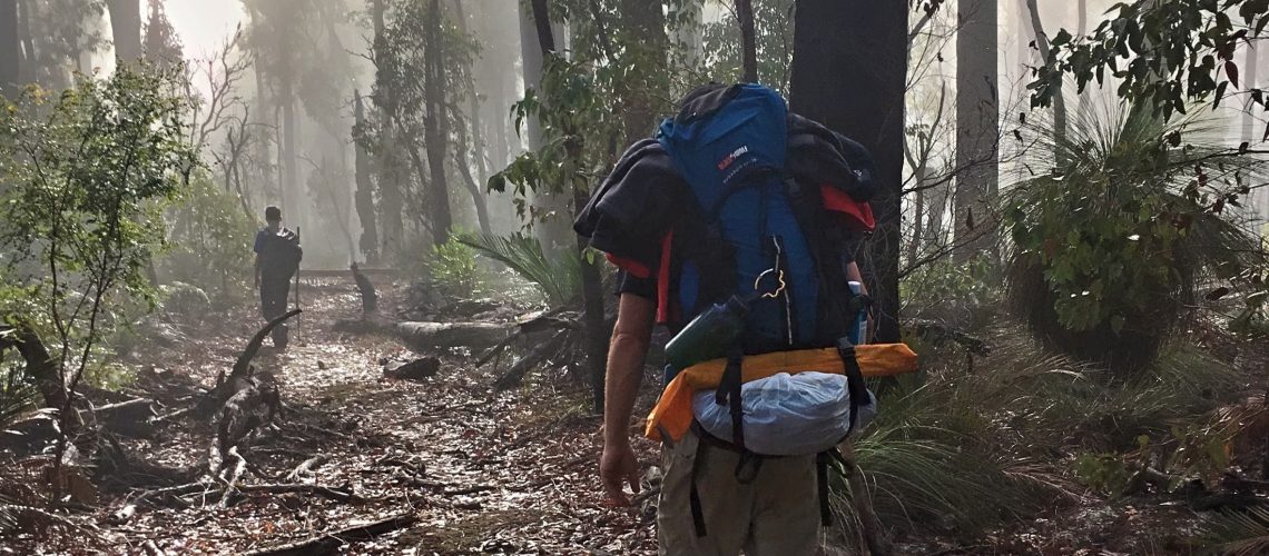 Father and son hiking with big backpacks