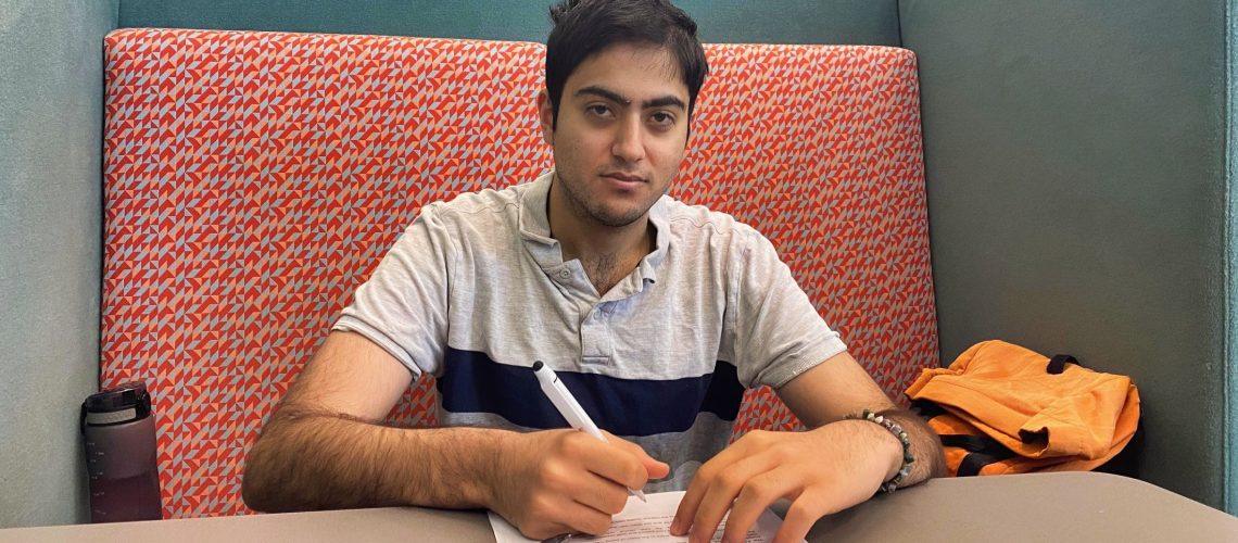 Teen boy working on paperwork on desk