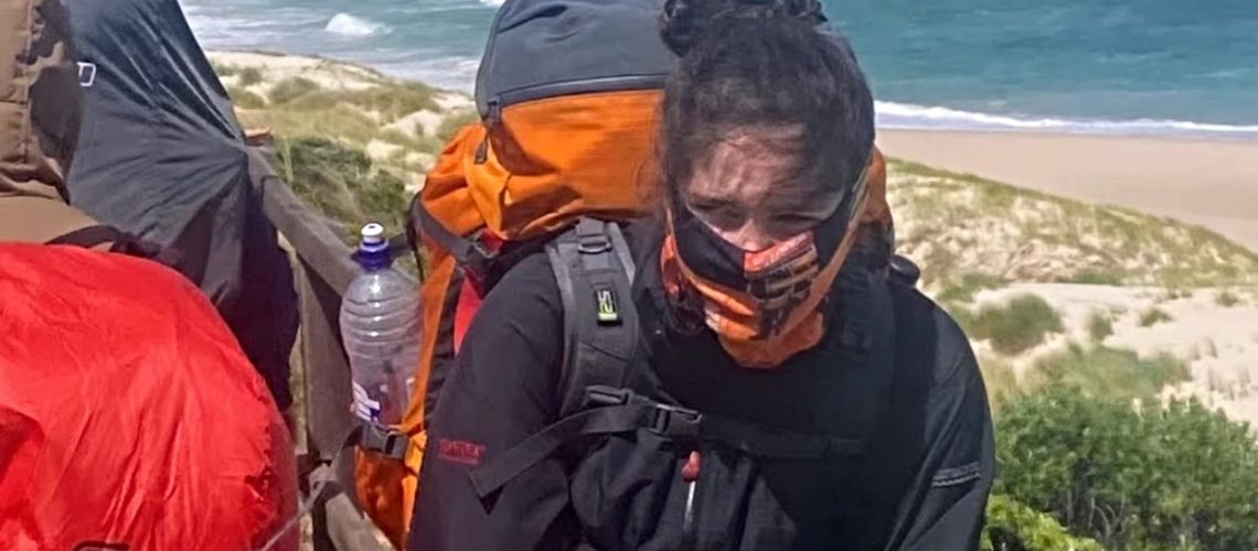teen girl protecting her face against very cold winds near the south coast on the Bibbulmun Track